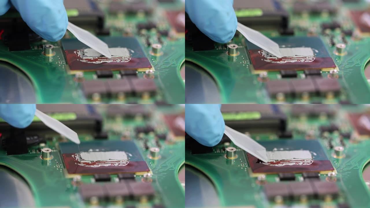 修理工在车间电脑主板上涂抹导热膏特写4k电影慢动作