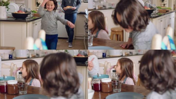 快乐的小男孩奔跑兴奋地与家人一起在家里的厨房里享受周末的早餐吃华夫饼