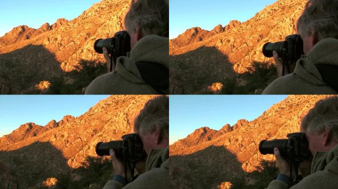 摄影师拍摄阳光照耀的山