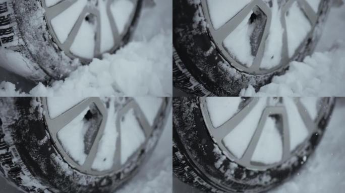 汽车大轮快速旋转并吐出了大雪，因为未知的驾驶员试图在冬天从雪乡道路上未经处理的情况下驾驶，积雪深