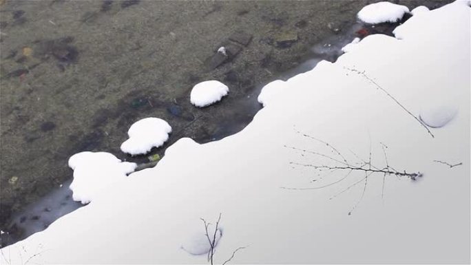 大量积雪落在溪流岸上