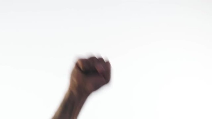 一个男人的手在白色的背景上紧握成拳头，忽起忽落。抗议和斗争的标志和象征。力量和勇气
