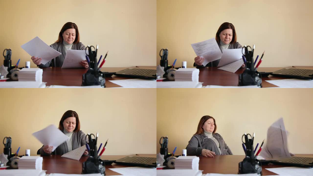 办公室里的女雇员将文件分发得很累