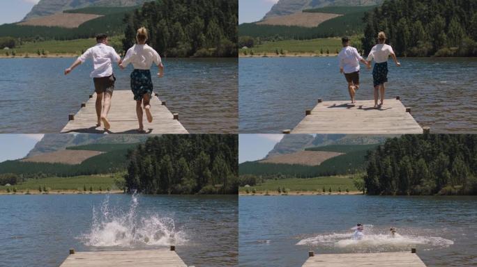 快乐的夫妇在湖里从码头上跳下来，在暑假里玩得开心