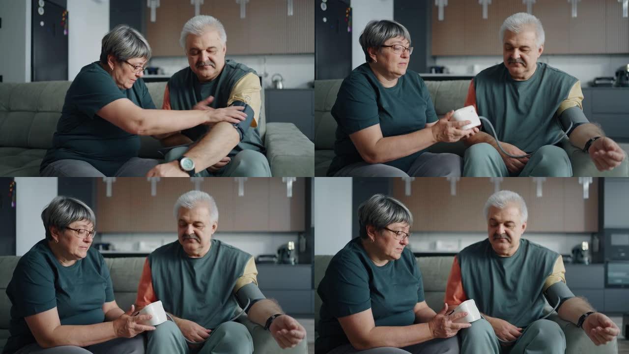 老年配偶在家血压，老年妇女帮助将袖口戴在丈夫的手臂上