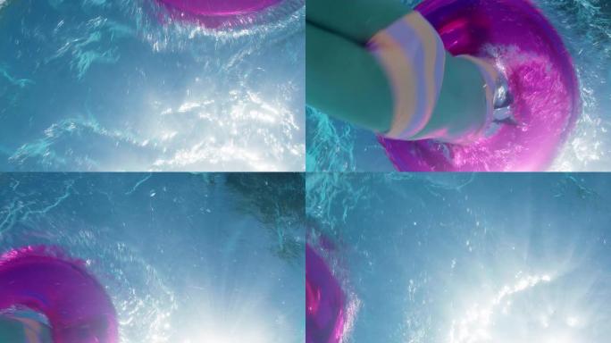 水下景观小女孩在游泳池里游泳，粉色游泳圈充气玩具孩子嬉戏地在水上嬉戏玩耍，漂浮着享受夏日pov 4k