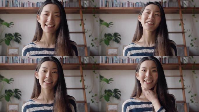 美丽的亚洲女人在家中使用网络摄像头进行视频聊天，分享激动人心的生活方式，与朋友聊天，看起来很惊讶，喜