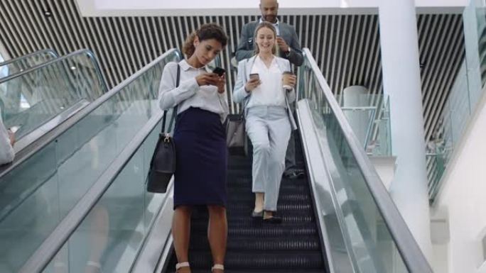 女商人上班迟到，走在自动扶梯上查看智能手机上的信息喝咖啡女主管在办公室大厅里匆匆忙忙4k镜头