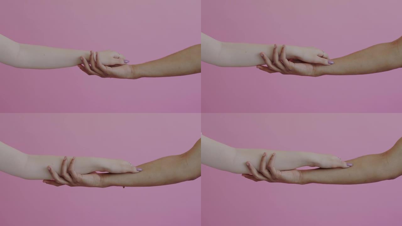 手臂的慢动作男性和女性触摸爱抚抚摸粉红色背景下的皮肤