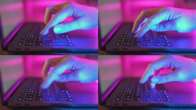 晚上在笔记本电脑上打字的人。女性使用键盘，用手指摇动按钮。互联网安全，网络攻击。时尚霓虹灯。紫外线红