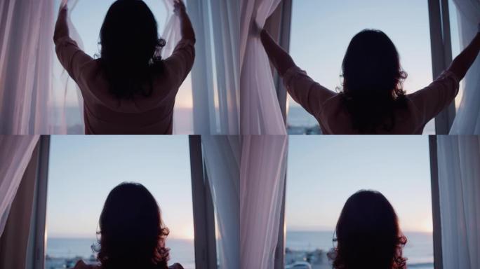 快乐的老旅行夫妇度假抵达酒店房间，看着窗外拍摄日落时美丽的海景，享受浪漫的周年纪念假期