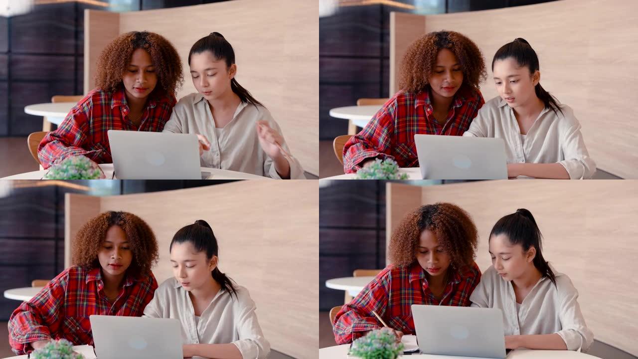 4K，同班同学的非洲亚裔女孩，坐下来找出需要在合作伙伴关系报告中包含的内容，然后在打印到笔记本电脑之