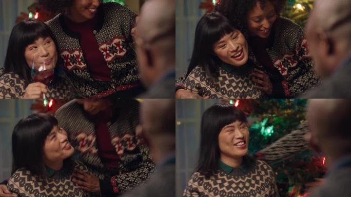 美丽的亚洲女人与非洲裔美国家庭最好的朋友一起庆祝圣诞晚餐，拥抱在家里享受节日假期4k