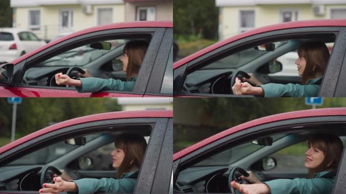 高兴的女人开车伸出手窗外