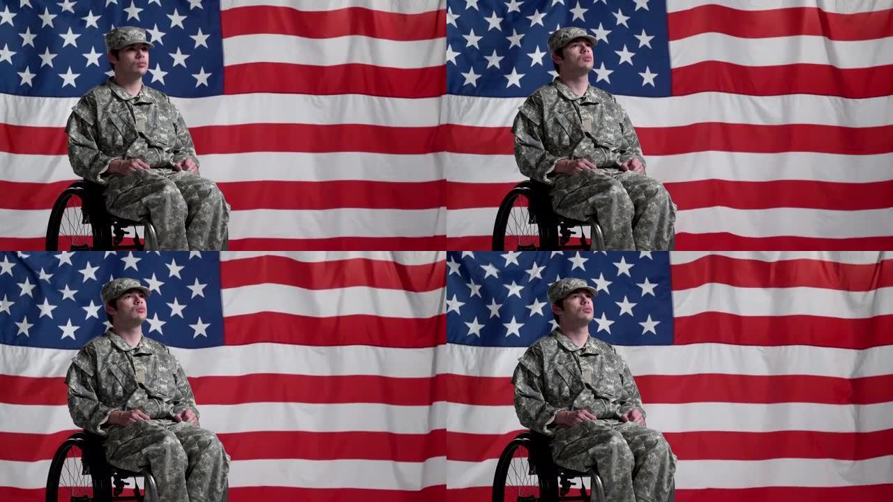 在美国国旗前坐轮椅的士兵