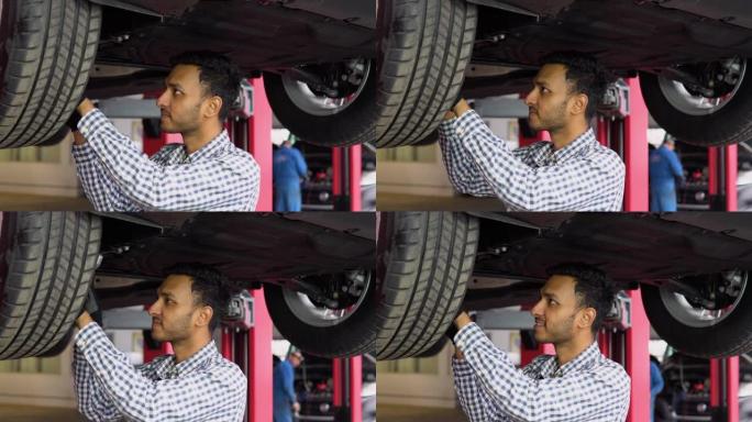 印度汽车修理工在汽车维修服务中工作。汽车服务、维修保养