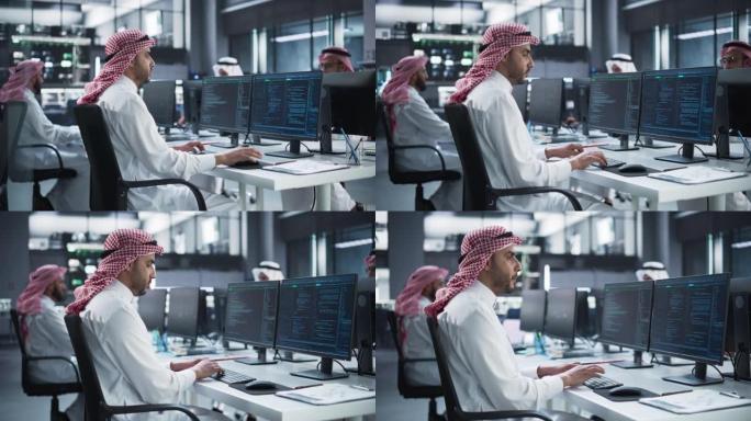 中东工程师在一家技术公司办公室的台式计算机上工作。经理与同事合作创新互联网和软件作为服务项目