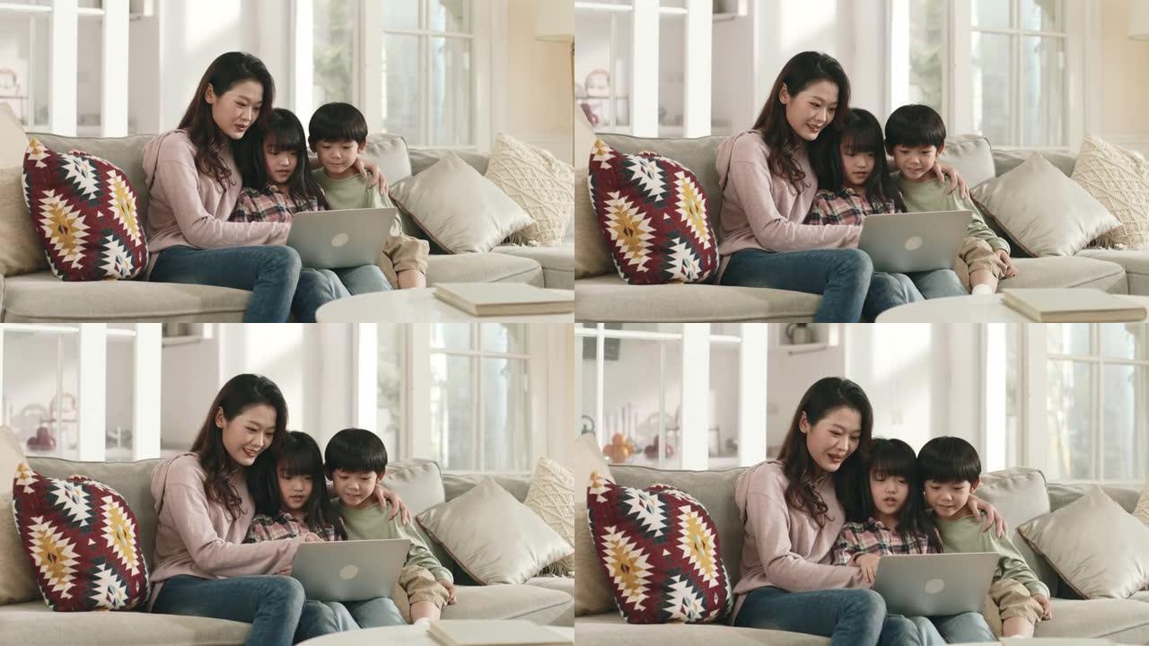 亚洲母亲和孩子在家里一起使用笔记本电脑