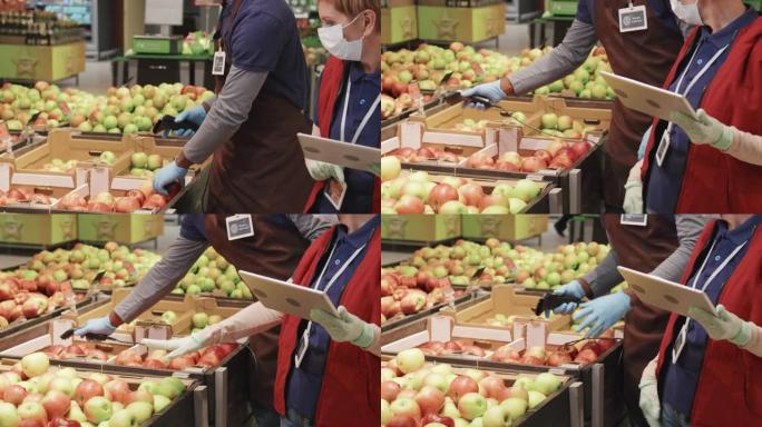超市工人用扫描仪扫描水果