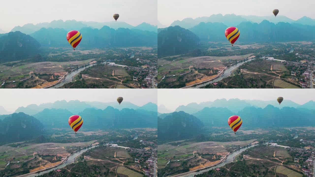 山谷上方红色热气球的鸟瞰图