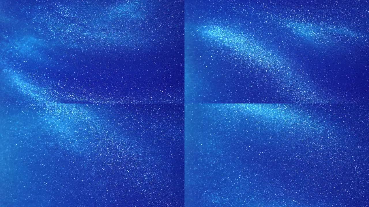 漂浮在蓝色液体中的白色发光颗粒。