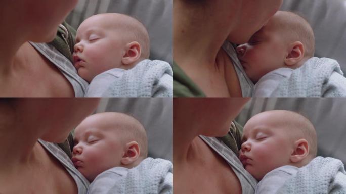 快乐的婴儿安然入睡享受慈爱的母亲抱着婴儿在家照顾孩子