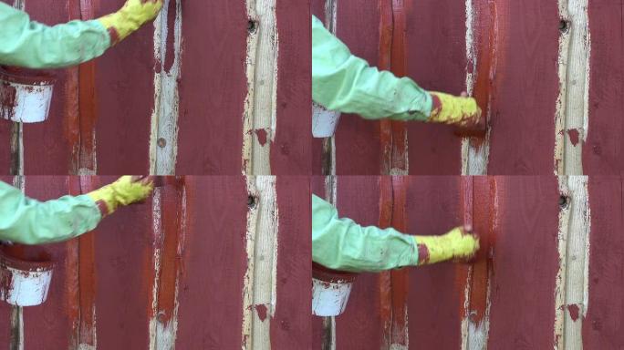 用画笔粉刷木制农家墙