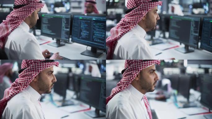 聪明的年轻阿拉伯专家在技术初创公司服务台部门工作，在多元化的办公室使用计算机。穿着传统中东服装的海湾