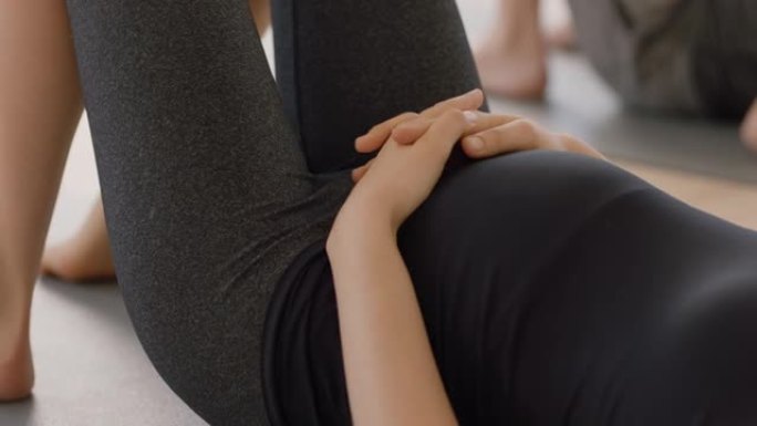 瑜伽课上的年轻孕妇躺在健身垫上休息锻炼后享受健身工作室的健康生活方式