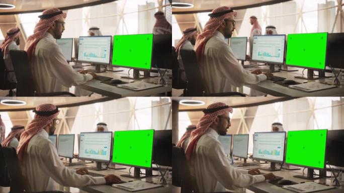 阿拉伯首席财务官在带有绿屏模拟显示的台式计算机上工作。年轻的中东专家分析企业银行账户，研究投资机会