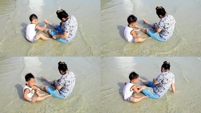 亚洲男孩和他的姑姑在海滩上玩得开心