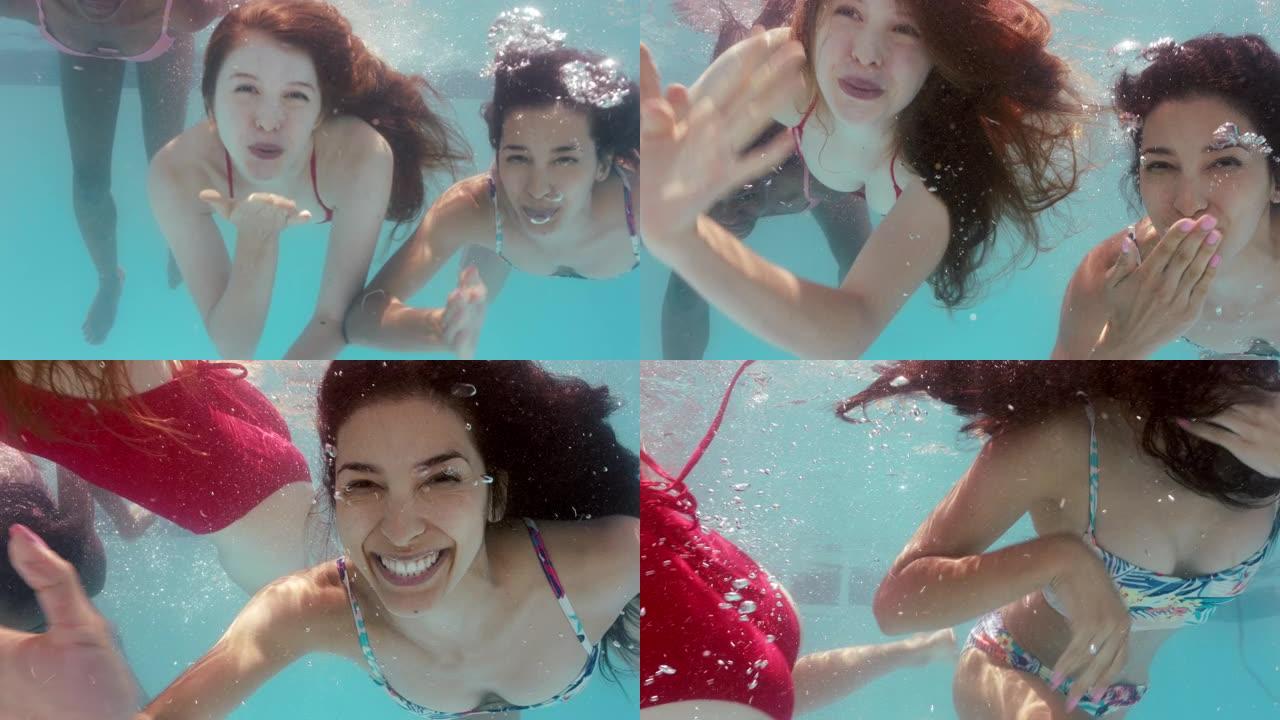 美丽的女孩在游泳池水下游泳，吹kises玩得开心，一起庆祝暑假，享受夏天游泳4k
