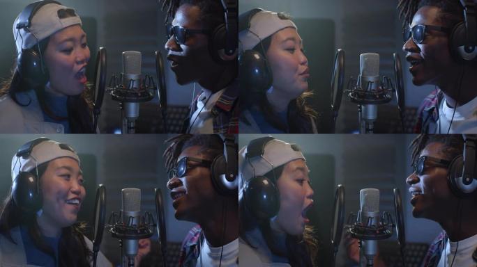 关闭两个多种族的专业歌手在录音室录制新专辑。才华横溢的黑人男性和亚洲女性年轻艺术家合作演唱一首浪漫的