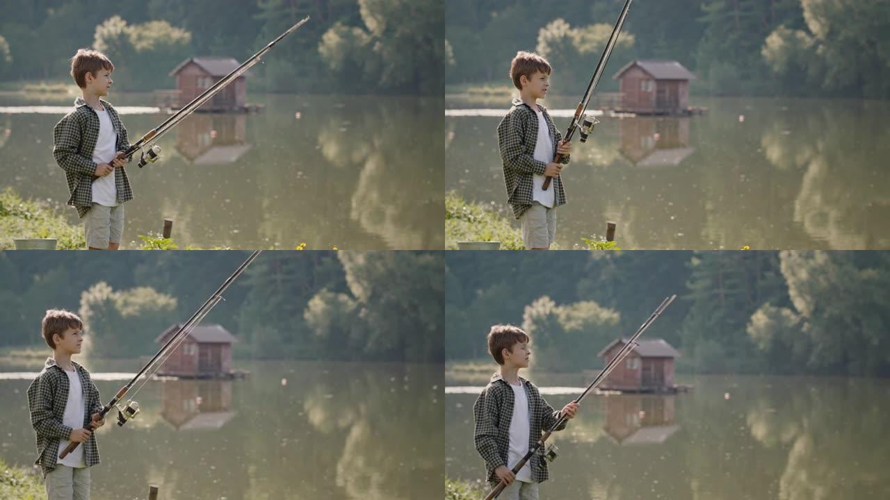 湖岸上有钓鱼竿的男孩