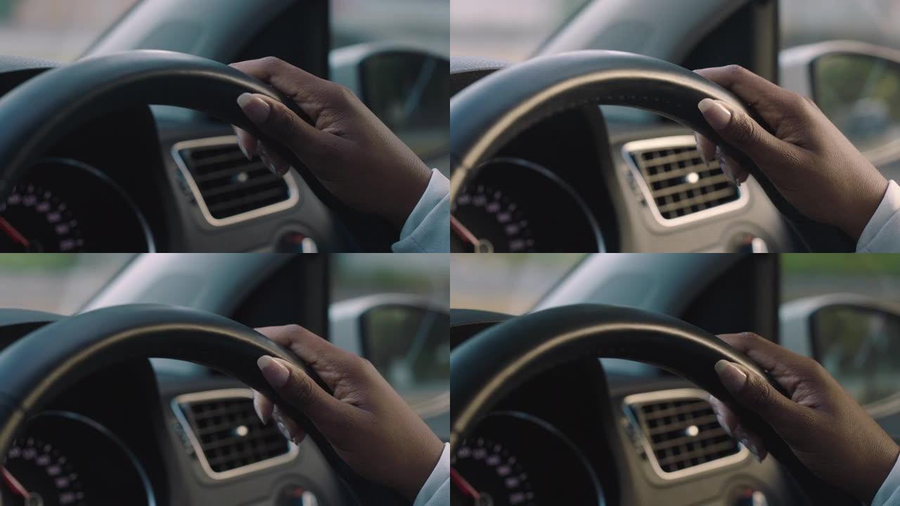女人用手在方向盘上驾驶汽车来控制城市中的车辆在高峰时间行驶到目的地的道路上