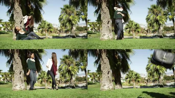 一个年轻女子坐在一棵树下的公园在白天，然后她的朋友遇见她，他们都离开了