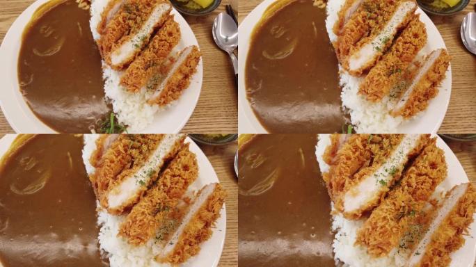 4K配米饭和酱汁的脆皮炸鸡片特写镜头