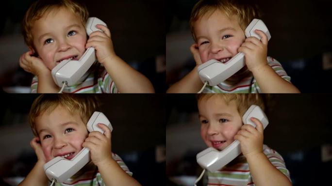兴奋的小男孩通过电话接收器说话