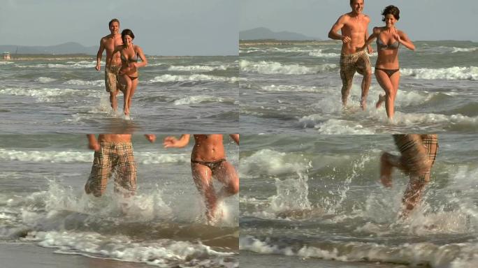 夫妇在海滩上奔跑