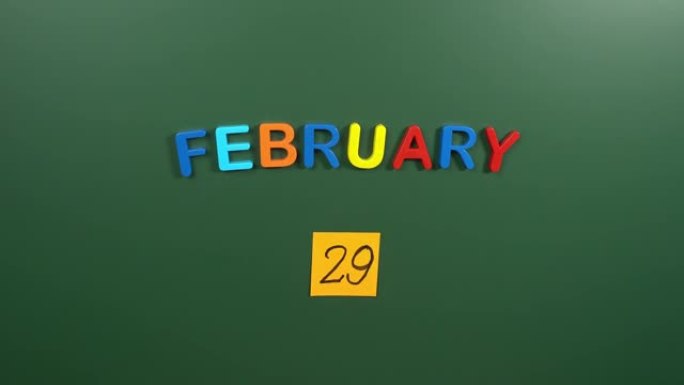 2月29日日历日用手在学校董事会上贴一张贴纸。29 2月日期。2月第二十九天。第29个日期编号。29