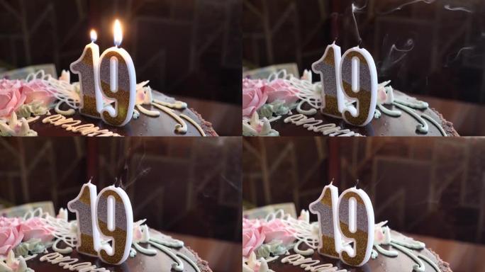 一个人以数字19的形式在蛋糕上吹灭蜡烛