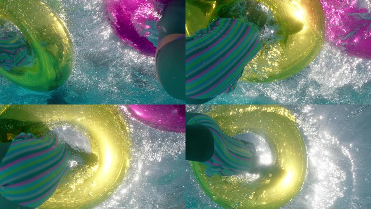 儿童在游泳池里泼水，带多色游泳管充气玩具嬉戏地玩乐在水上漂浮享受暑假水下景观