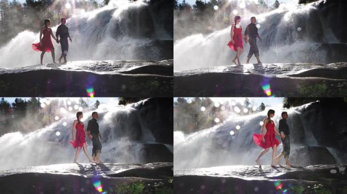 夫妇在瀑布边散步