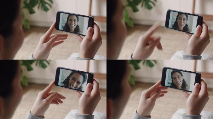 年轻女子在家中使用智能手机进行视频聊天，与朋友聊天，享受对话，在手机上分享生活方式