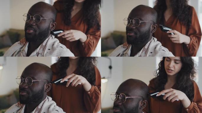非洲裔美国男子的高加索妇女剃光头