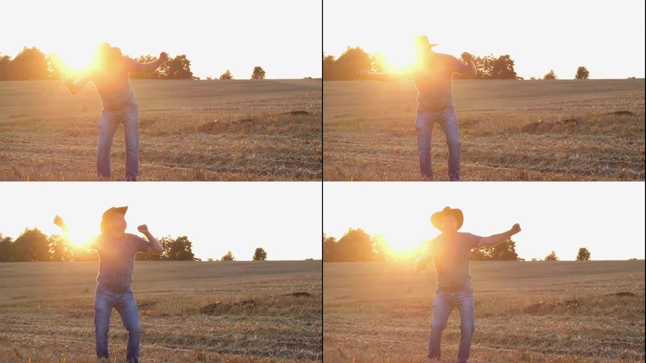 一个满意的农民在田间表演了一场有趣的舞蹈。田野中的剪影日落或日出