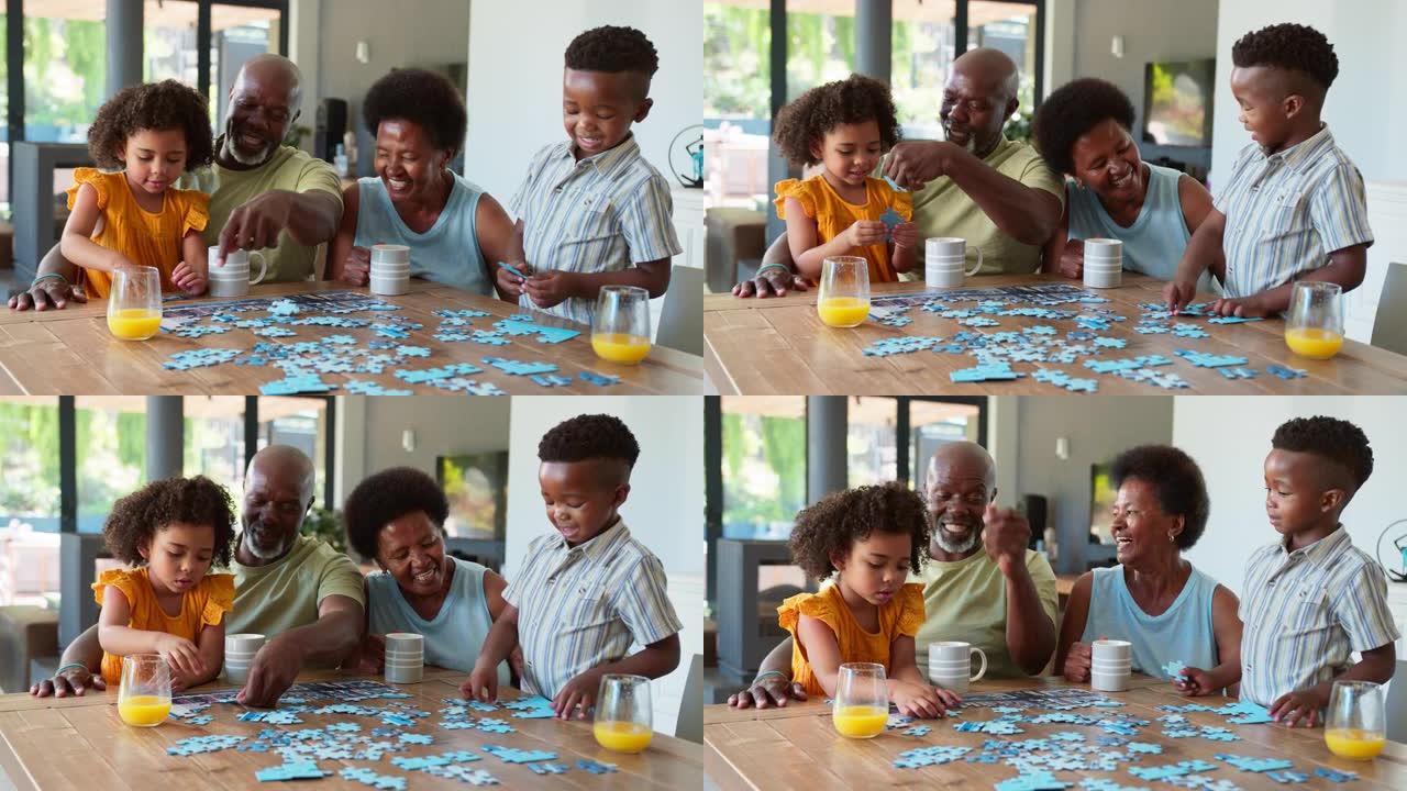 家庭与祖父母和孙子在家里的桌子上做拼图游戏