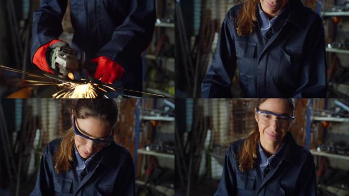 年轻的女机械师，穿着工作服，戴着护目镜，在她的车间里微笑着看着相机。专业焊工使用角磨床打磨金属火花飞