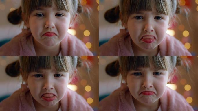 肖像悲伤的小女孩在家里看起来不开心的孩子