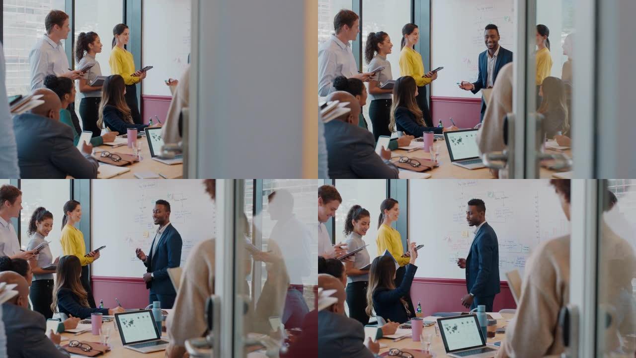 非裔美国商人在办公室会议上在白板上展示想法，与公司团队项目经理在会议室演讲中与同事讨论战略
